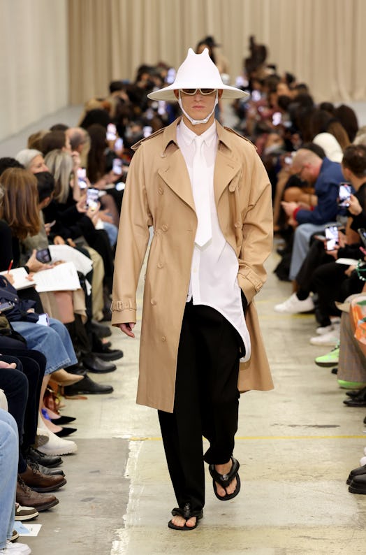 A male model walking the runway at the Burberry show during London Fashion Week September 2022 in a ...