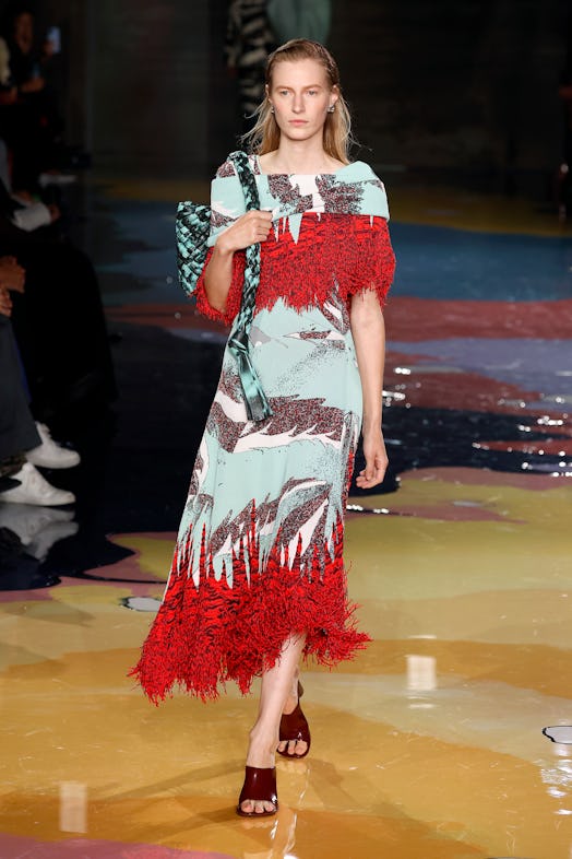 A model walks the Bottega Veneta Spring 2023 runway in a multicolored printed dress as part of the M...