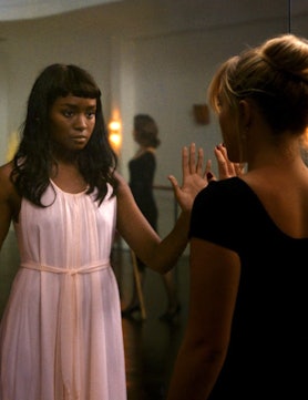Kiki Layne and Florence Pugh holding up their hands to each others in a still from 'Don't Worry Darl...