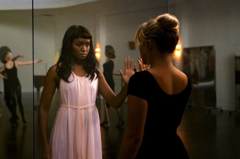 Kiki Layne and Florence Pugh holding up their hands to each others in a still from 'Don't Worry Darl...