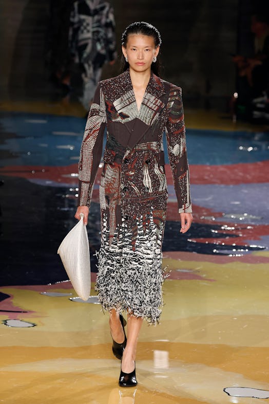 A model walks the Bottega Veneta Spring 2023 runway in multicolor pattern skirt and blazer.