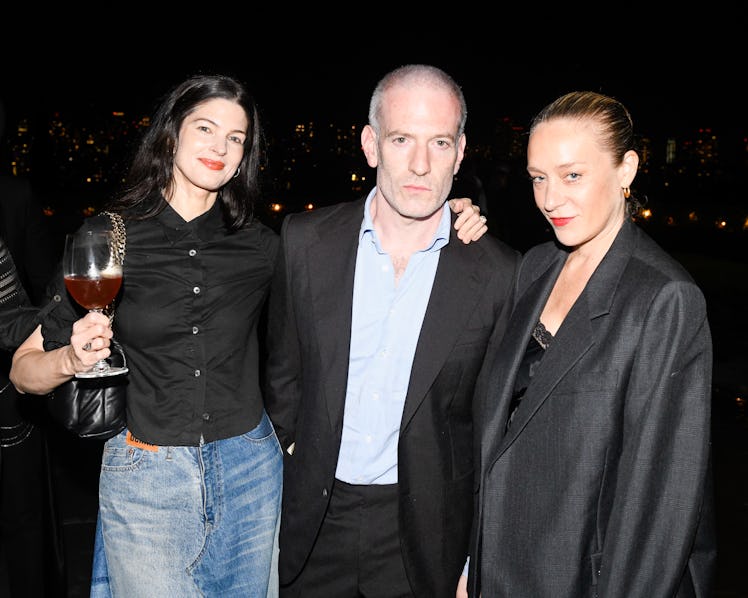 Katie Serva, Mel Ottenberg, and Chloë Sevigny at a rooftop party