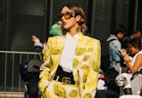 a guest wears a bold suit at milan fashion week