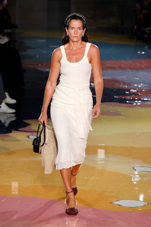 A model walks the Bottega Veneta Spring 2023 runway in white dress as part of the Milan Fashion Week...