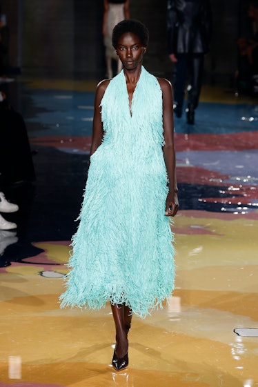 A model walks the Bottega Veneta Spring 2023 runway in a turquoise maxi furry dress.
