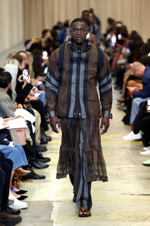 A male model walking the runway at the Burberry show during London Fashion Week 
