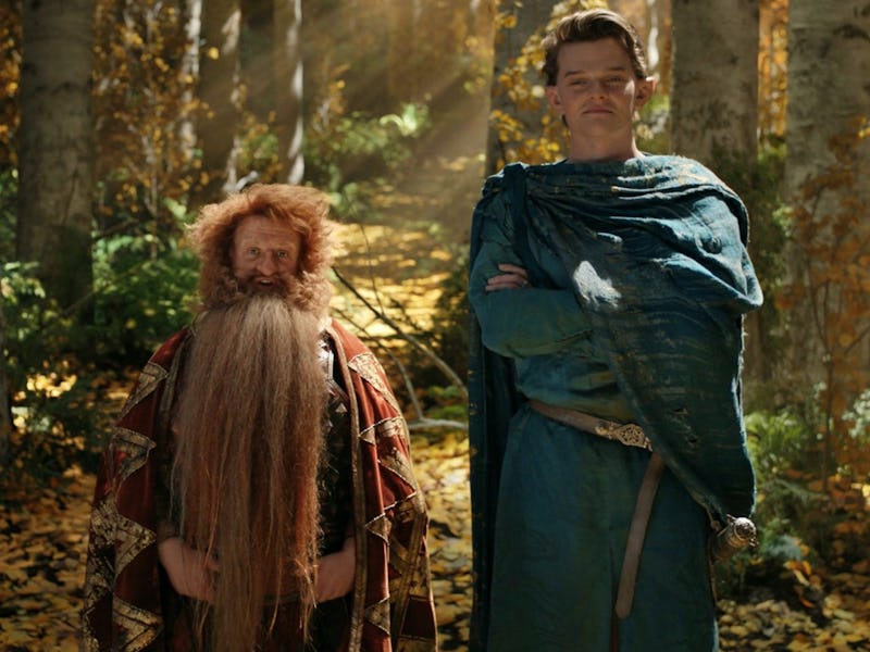 Prince Durin IV (Owain Arthur) and Elrond (Robert Aramayo) stand in a forest together in The Lord of...