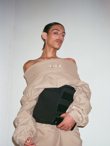 A person posing in a sweater designed by Luar