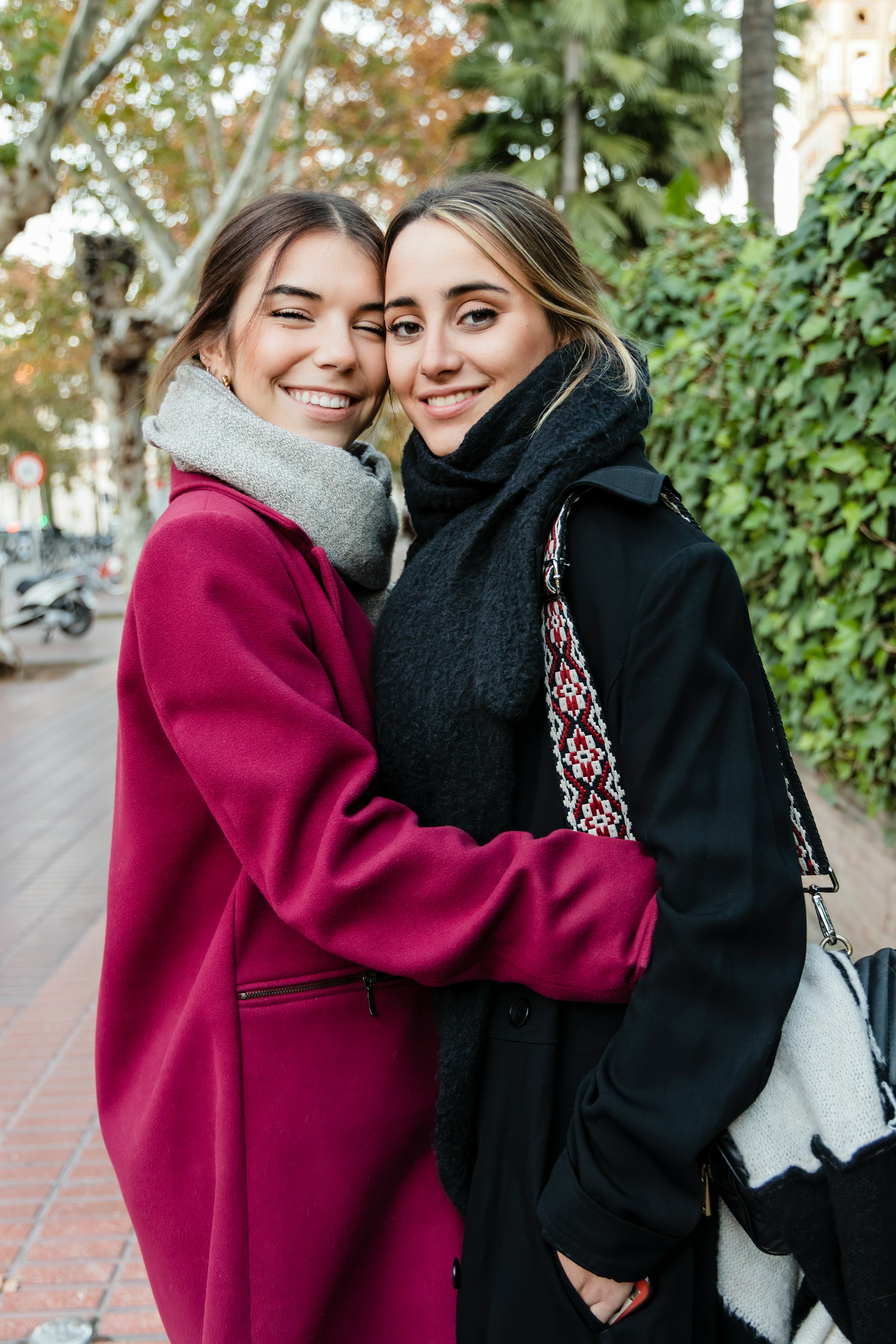 A young couple hugging in their coats on the most romantic day in October 2022.