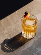 Photo of Old Fashioned Cocktail with a cherry and orange slice
