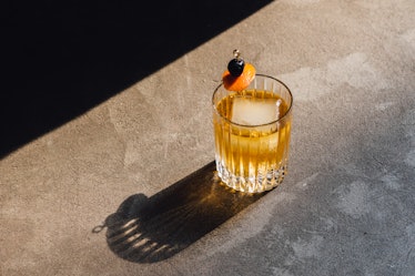 Photo of Old Fashioned Cocktail with a cherry and orange slice