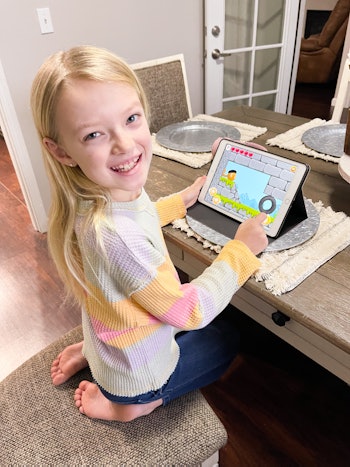 child smiling while playing codespark