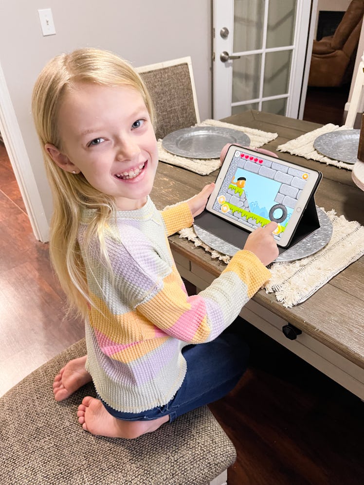 child smiling while playing codespark