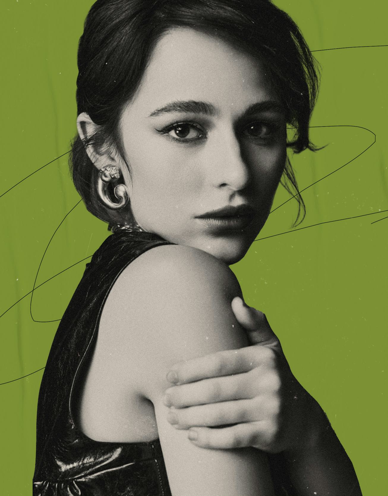 Actress and singer Sophia Anne Caruso, with her hand on her shoulder, wearing a black dress and loos...