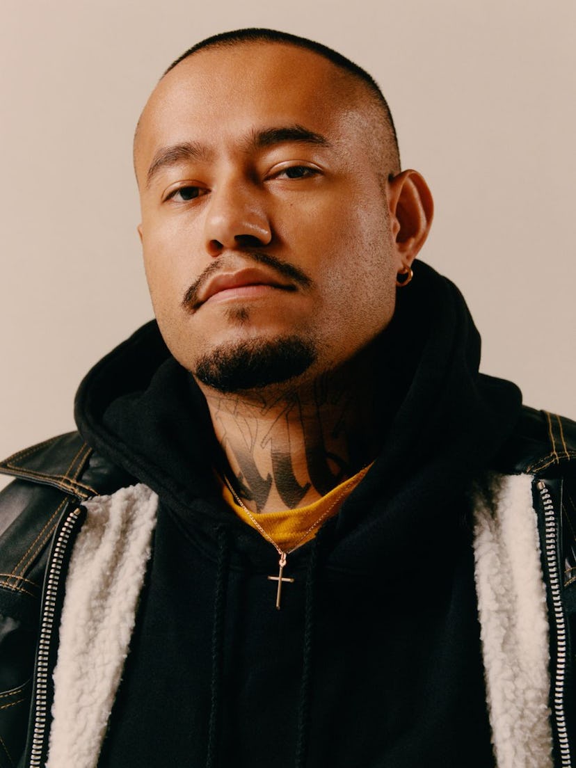 A portrait of Victor Barragán wearing a black hoodie and jacket