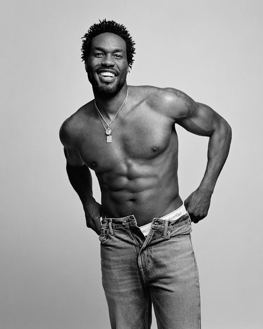 A shirtless Yahya Abdul-Mateen II holding up his jeans in a Calvin Klein campaign