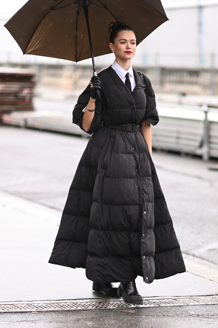 Valeria Lipovetsky is seen wearing a Dior puff coat, Dior shirt and tie and black Dior gloves outsid...