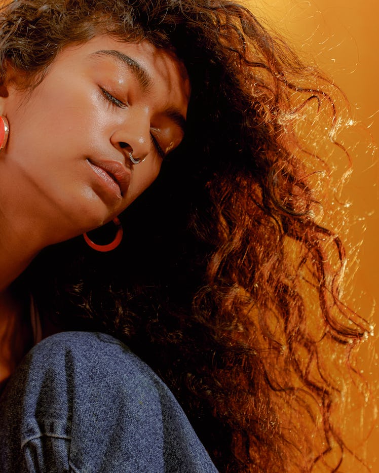 Young woman with her hair blowing in the wind when Mercury retrograde fall 2022 ends on Oct. 2.