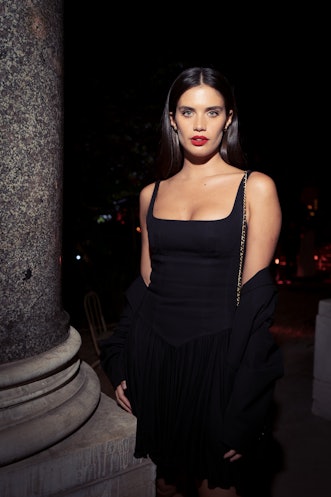 Sara Sampaio posing in a black mini dress at the Lancôme fashion week in Paris