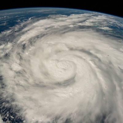 Hurricane Ian, swirled into a spiral, aerial view from the ISS over the Caribbean Sea.