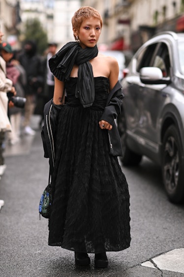 A guest is seen wearing a black Rochas dress and black scarf outside the Rochas show during Paris Fa...