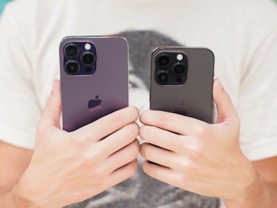 An iPhone 14 Pro Max in Deep Purple and iPhone 14 Pro in Space Black
