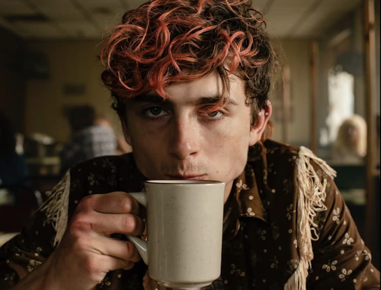 Timothee Chalamet drinking coffee in a diner in the movie Bones & All
