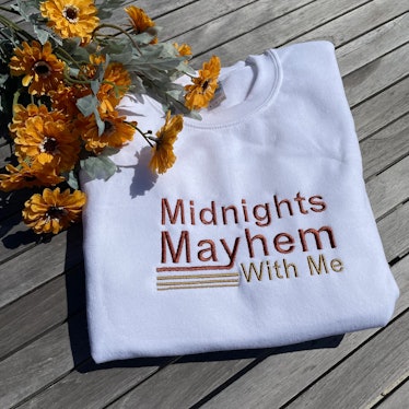 This sweatshirt is some of the Taylor Swift 'Midnights' merch on Etsy. 