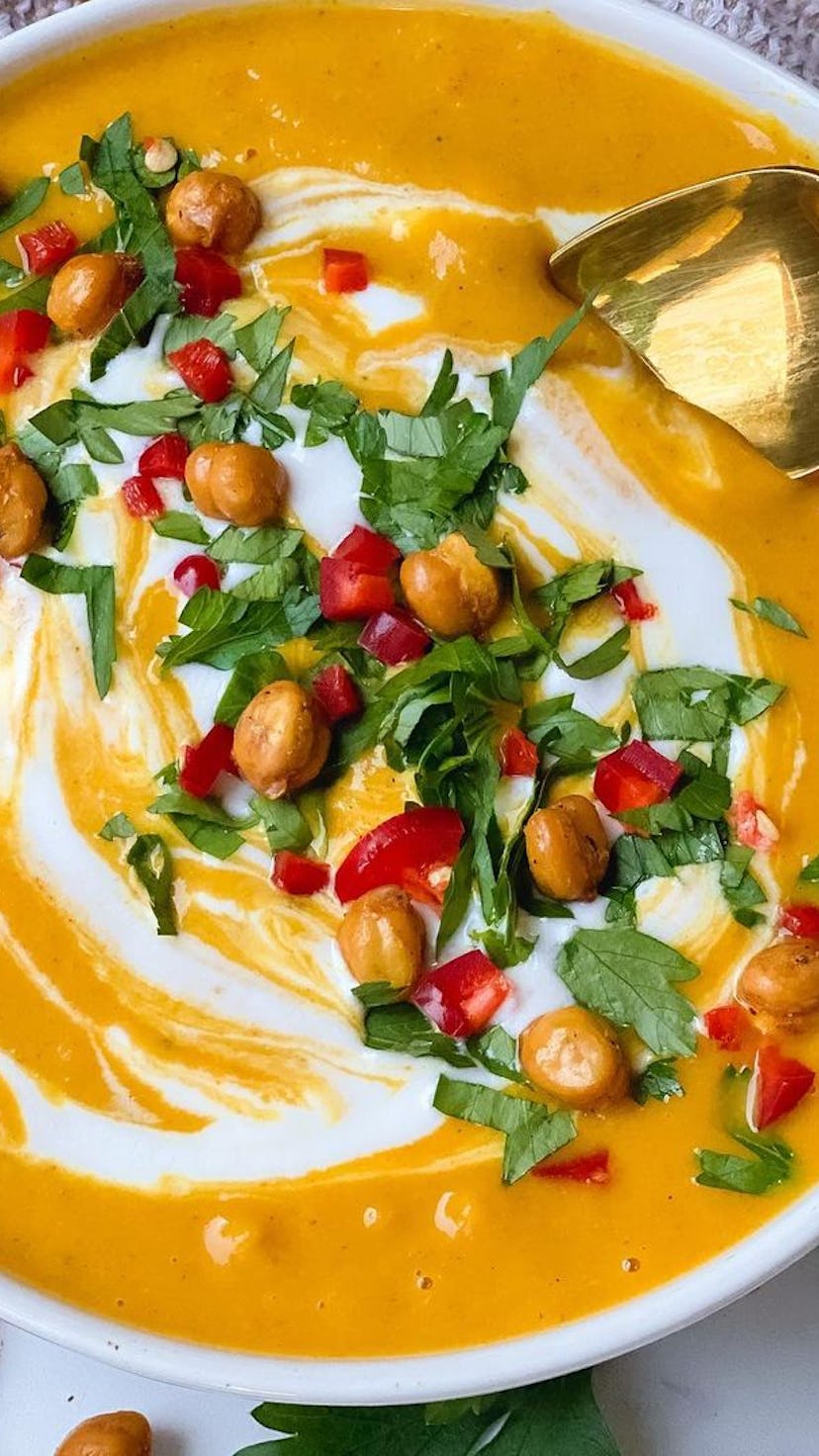 Bowl of butternut squash soup and the coconut curry garnished with greens and cream, perfect for fal...