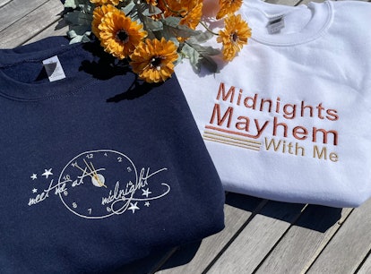 These sweatshirts are part of the Taylor Swift 'Midnights' merch on Etsy. 