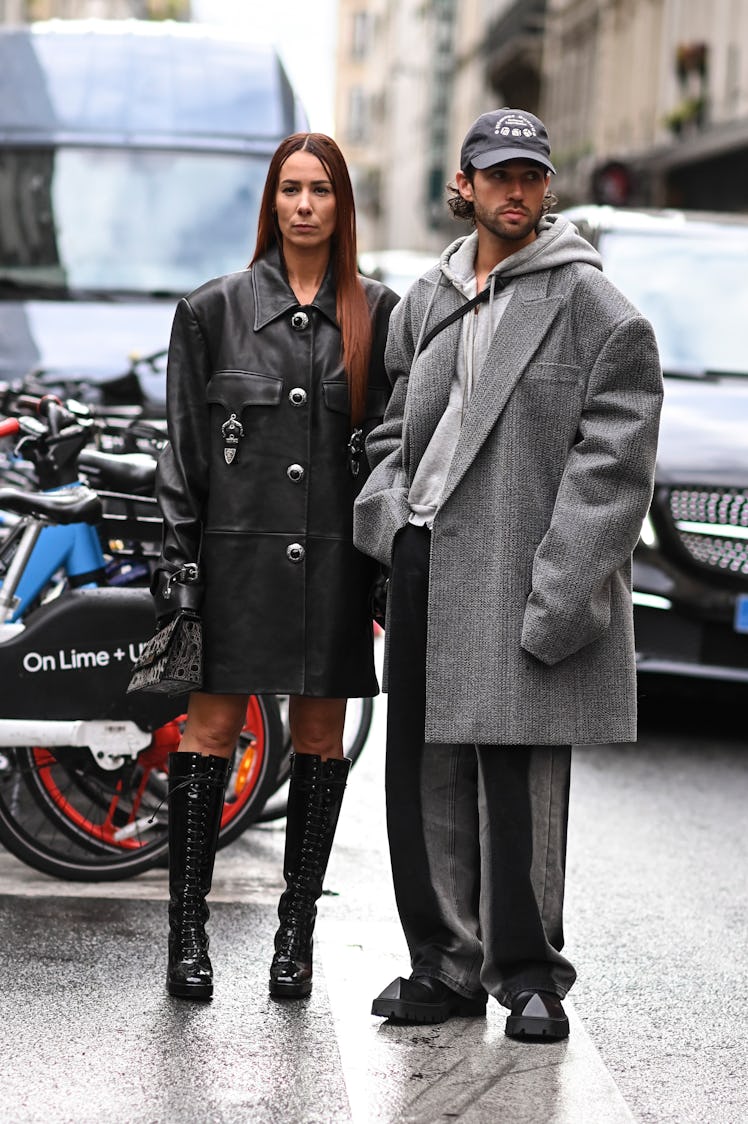 Alice Barbier is seen wearing a black leather coat and black boots with Sebastien Roques wearing a g...