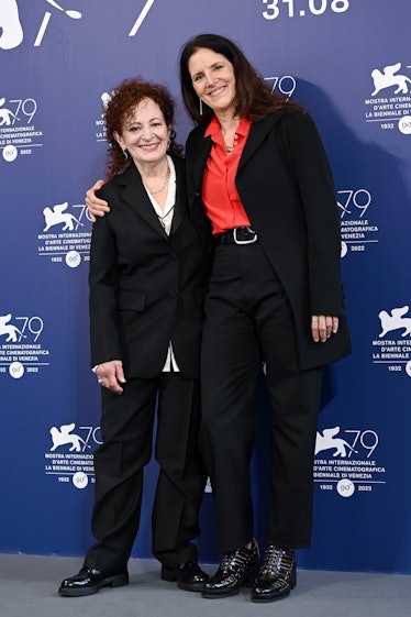 Nan Goldin and Laura Poitras wearing black suits at the Venice Film Festival