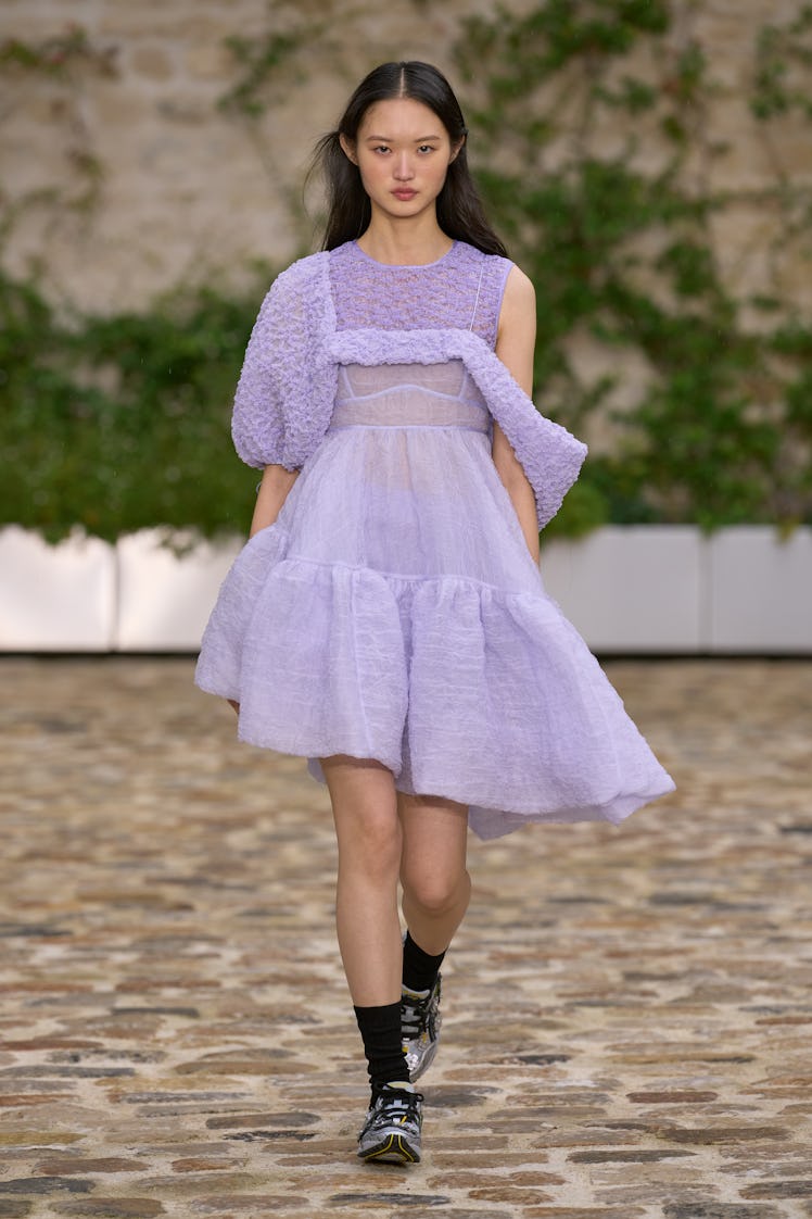 A model wearing Cecilie Bahnsen lavender cocktail one-sleeved dress at Paris Fashion Week Spring 202...