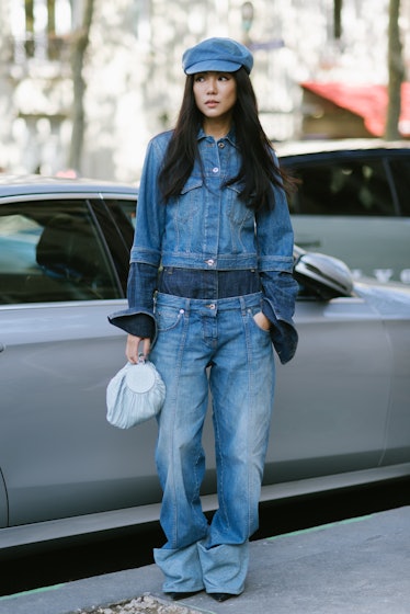 Yoyo Cao poses wearing Loewe denim jacket and pants after the Loewe show at the Garde Republicaine d...
