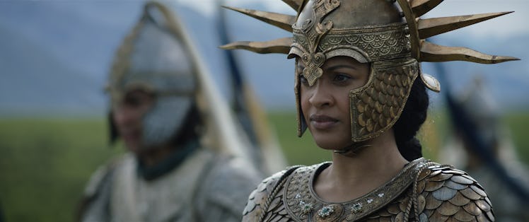 A character wears a helmet on the battlefield in Rings of Power.