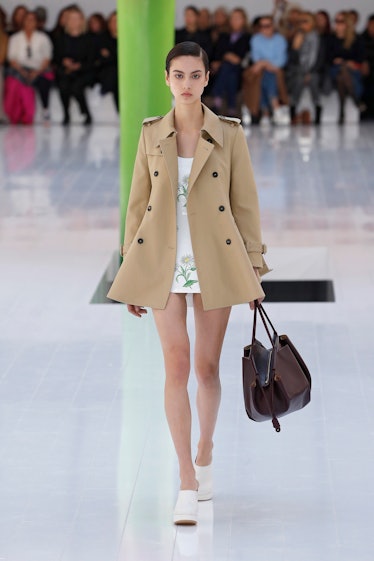 A model wearing Loewe nude coat and flower dress at Paris Fashion Week Spring 2023