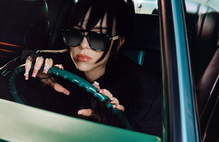 Billie Eilish driving a car in a Gucci eyewear campaign