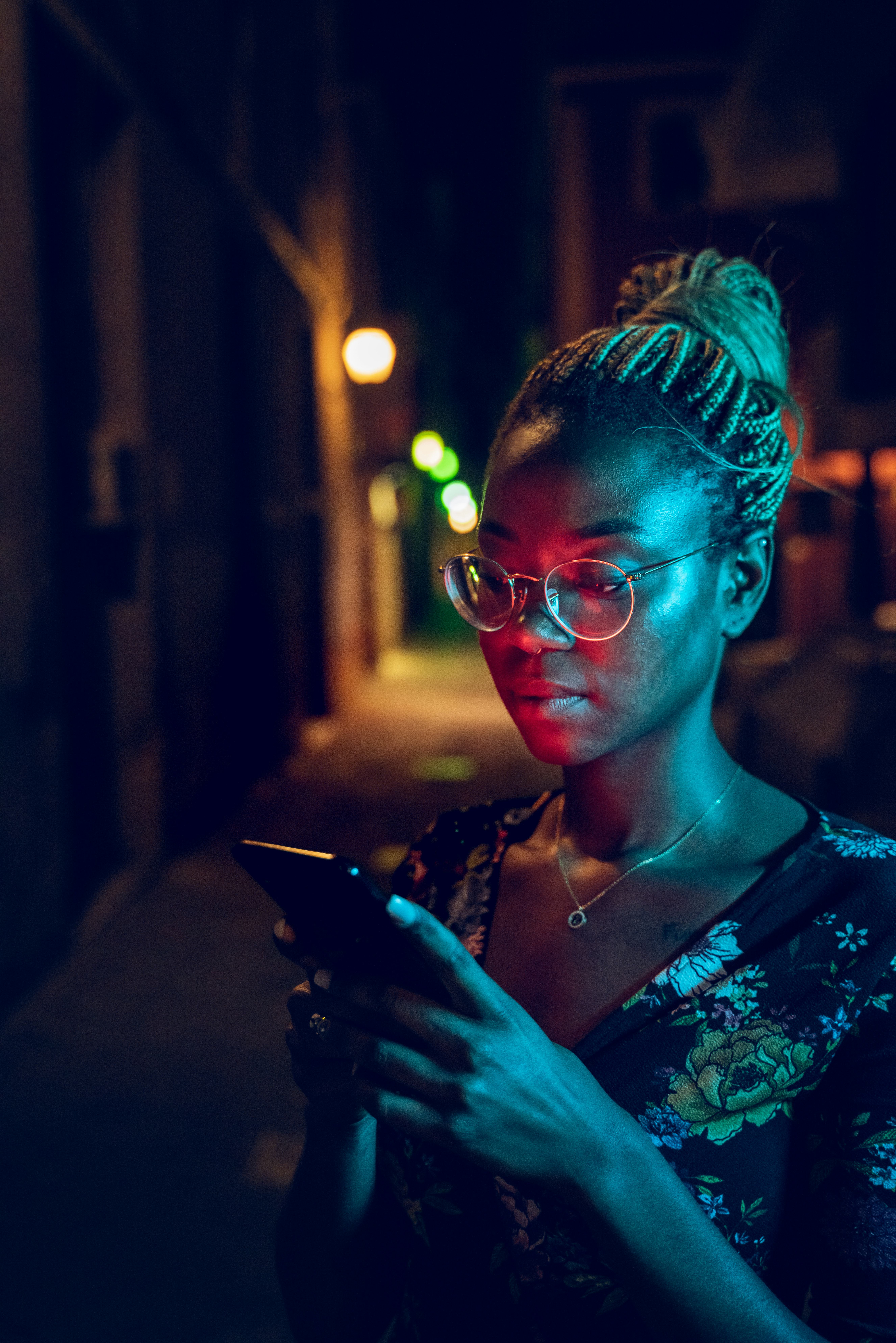 Young woman reading her zodiac sign's Mercury retrograde fall 2022 horoscope on her phone, which wil...