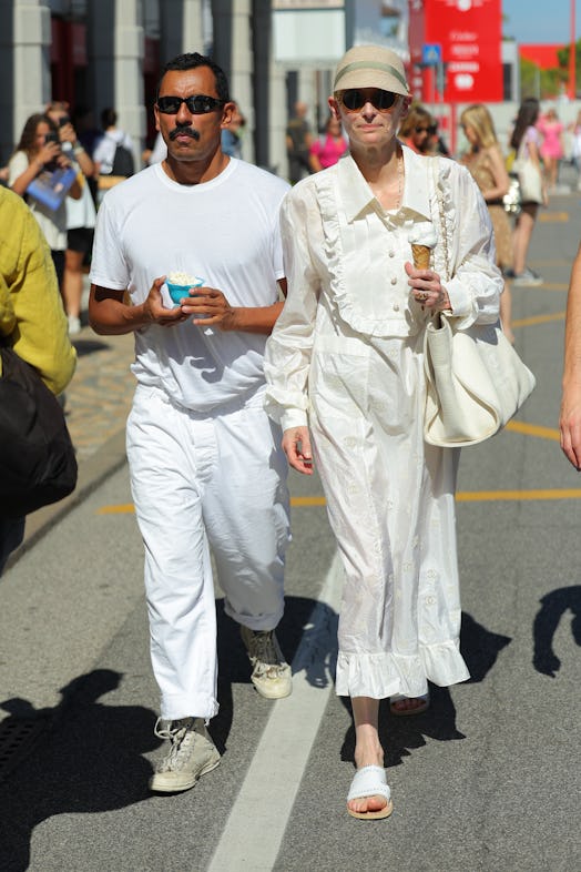 Haider Ackermann and Tilda Swinton wearing all white while in Italy for the Venice Film Festival