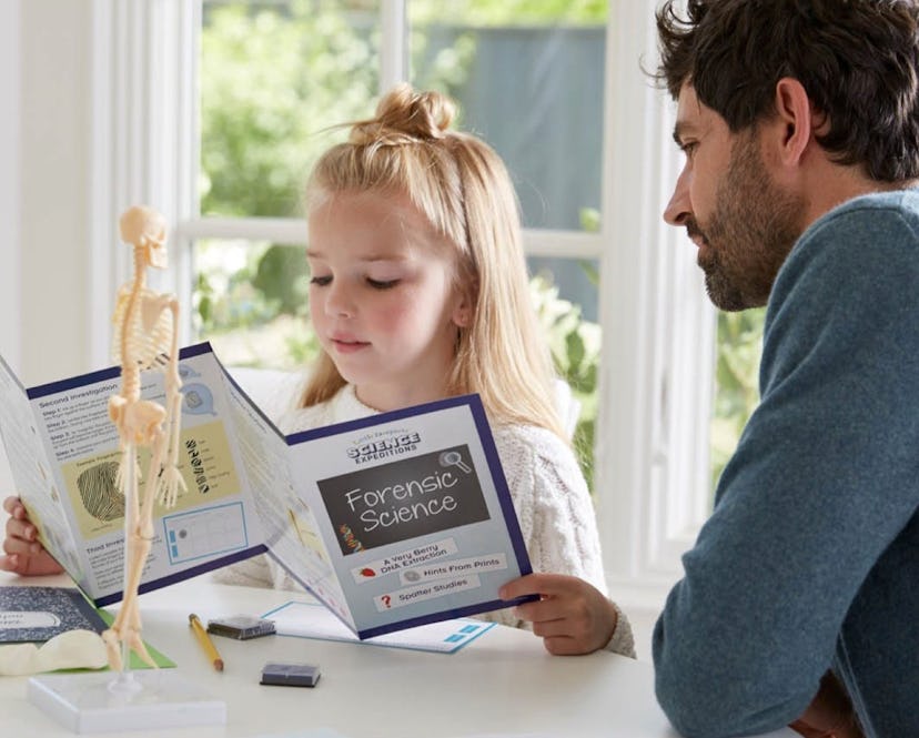 child playing with little passports science expeditions box