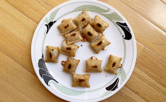 Slightly burnt pizza rolls on a plate.