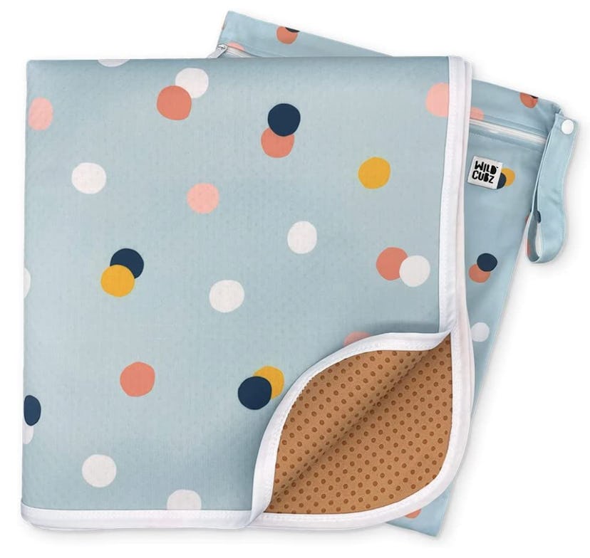 Pale blue polo dot printed Wild Cubs splat mat for babies with included bag