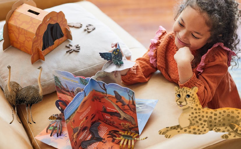 young child playing with Little Passports toy animals