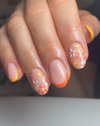 fall manicure with orange daisies