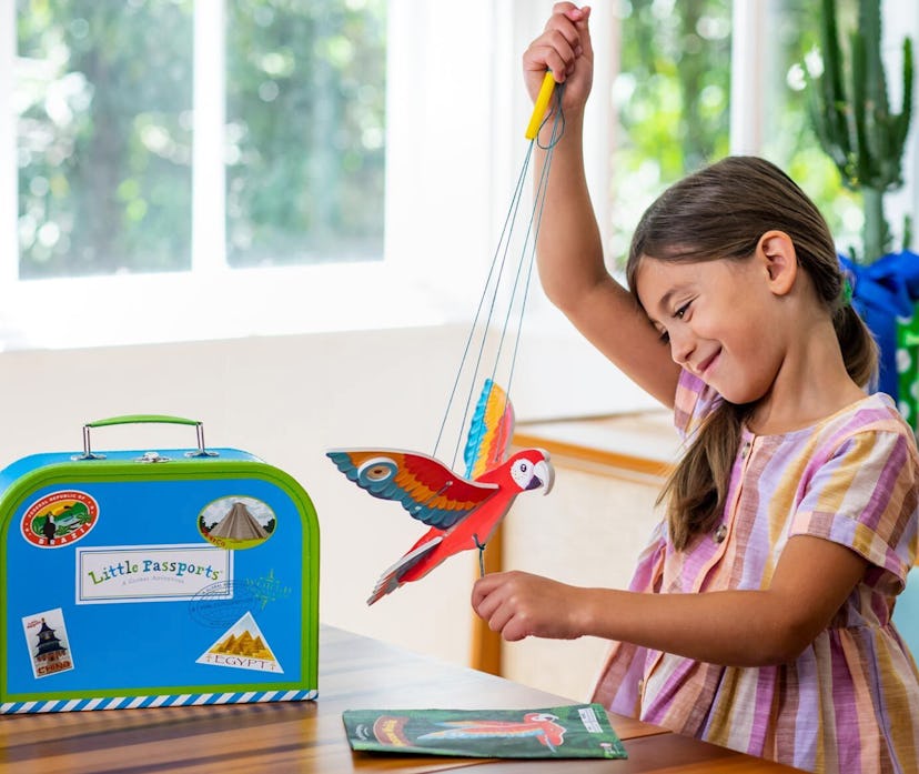 child playing with little passports world edition box