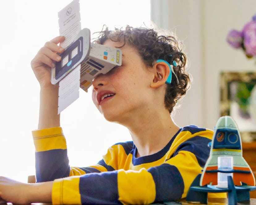 kid playing with little passports space quest box