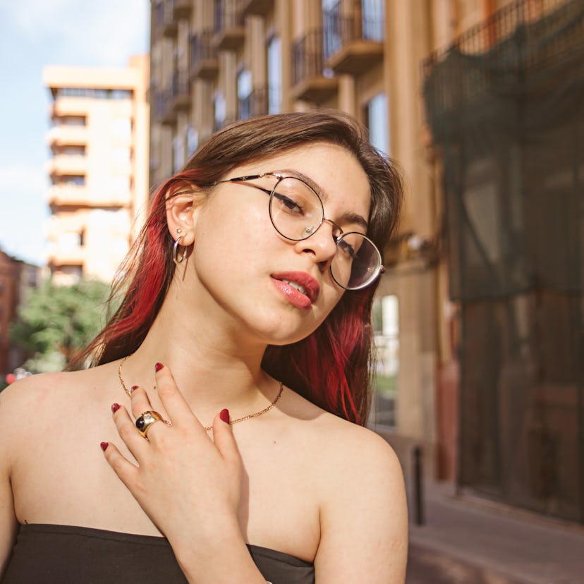 Young woman in glasses on the street during the September 2022 full Harvest moon, which will affect ...