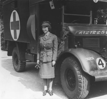 A young Queen Elizabeth II standing by an Auxiliary Territorial Service first aid truck 