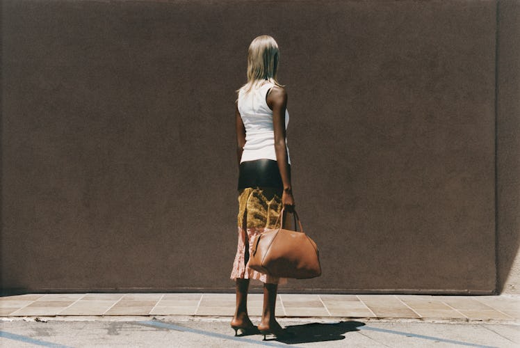 Prada bag, tank top, and skirt; Manolo Blahnik shoes.