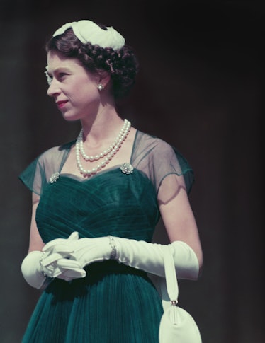 Queen Elizabeth II wearing an emerald green dress with white accessories